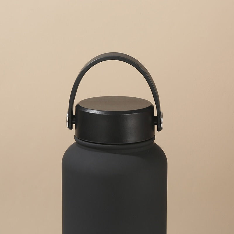 Leak-proof women's insulated water bottle, keeps drinks hot/cold. Ergonomic handle for travel & gym.