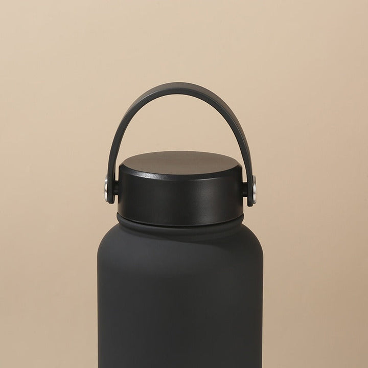 Leak-proof women's insulated water bottle, keeps drinks hot/cold. Ergonomic handle for travel & gym.