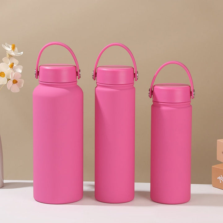 Women's insulated flask with ergonomic handle, keeps hot drinks hot & cold drinks cold. Leak-proof design.