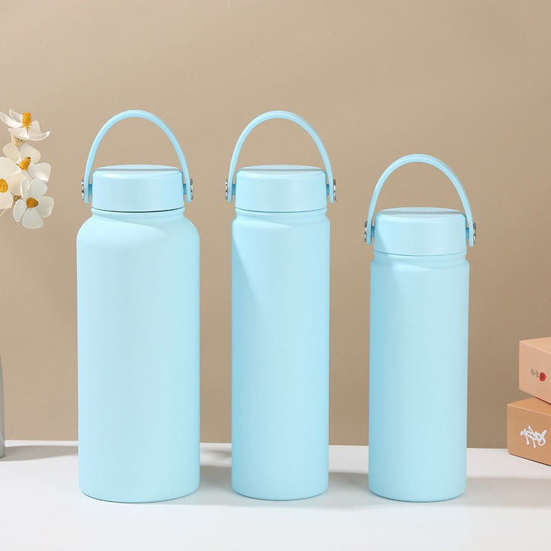 Reusable women's insulated water bottle with ergonomic handle, stainless steel, eco-friendly hydration solution.