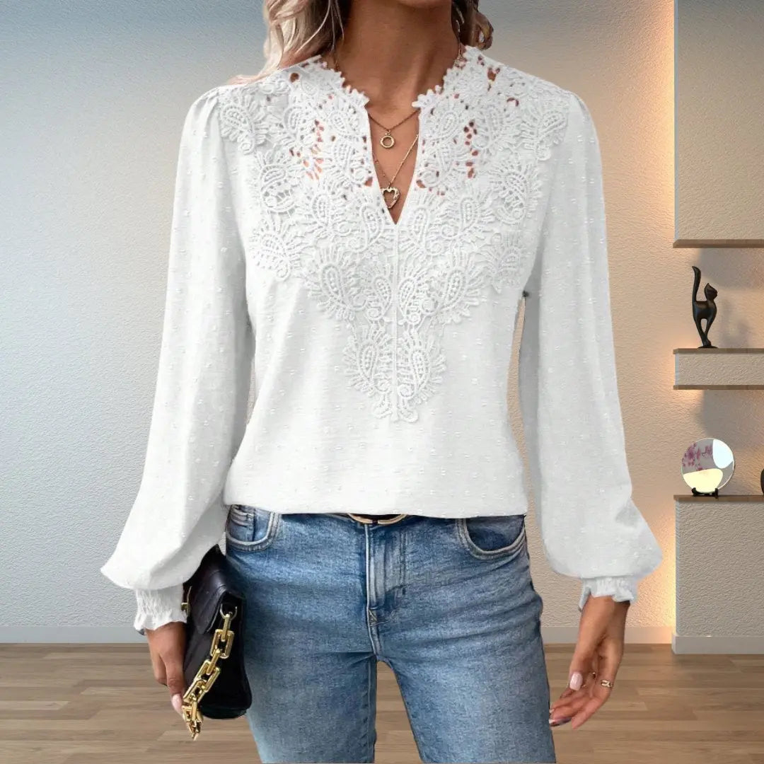 Women's patterned long sleeve V-neck top with romantic lace trim, intricate design & smocked cuffs.