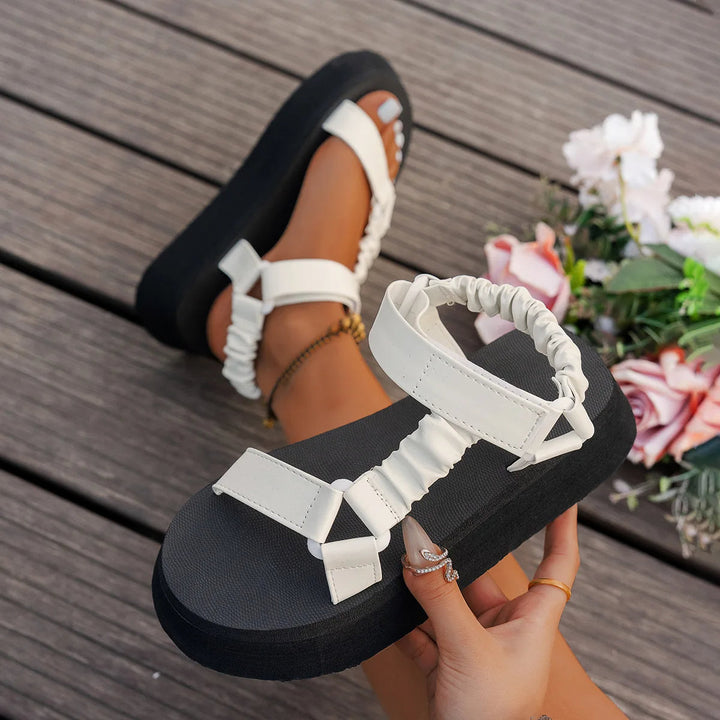 Shimmering iridescent platform sandals for women, showcasing the chunky sole, adjustable strap, and comfort features.