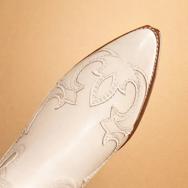 Close-up of stylish women's embroidered knee-high western boots, showcasing boho chic & fashion details. Womens shoes.