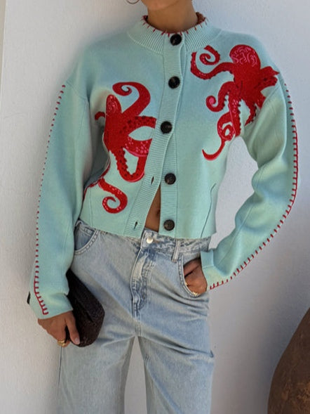 Soft knit women's cardigan with an intricate octopus pattern. Button-front closure, long sleeves.