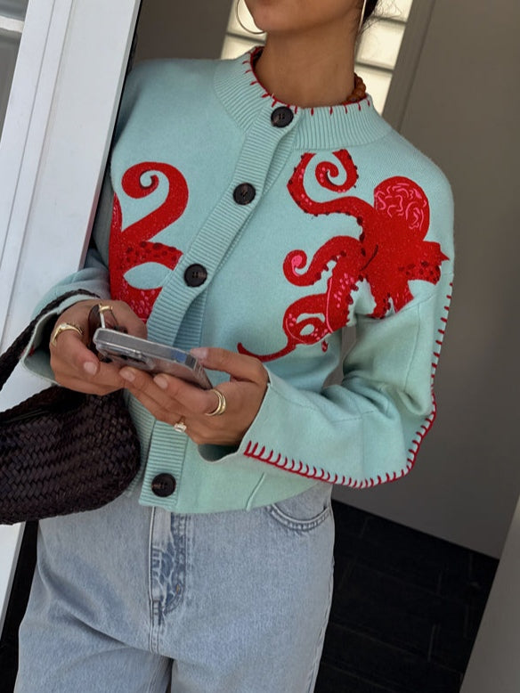 Women's knit cardigan featuring a distinctive octopus pattern. Button front, suitable for everyday wear.