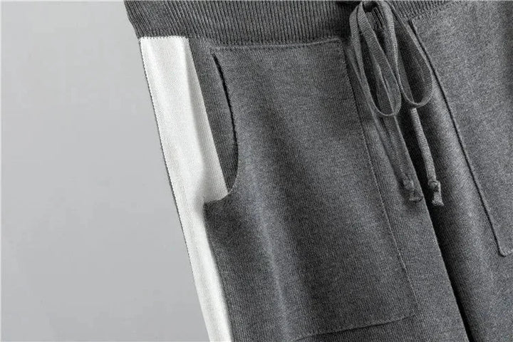 Plus size women's color-block knit tracksuit. Mock-neck top & tapered pants. Comfortable loungewear.