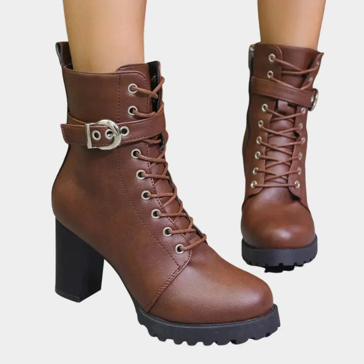 Women's lace-up block heel ankle boots with buckle strap & chunky lug sole for fall fashion.