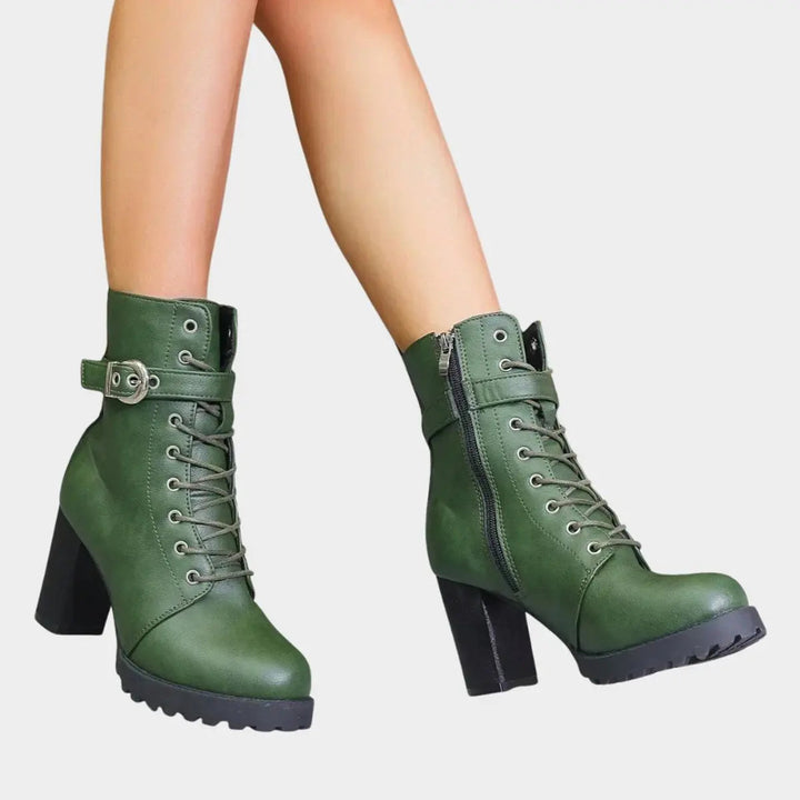 Combat-inspired women's ankle boots: lace-up, buckle strap, sturdy block heel, chunky lug sole.
