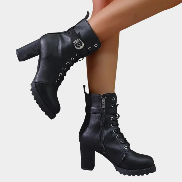 Chunky block heel women's ankle boots with lace-up detail & buckle strap. Combat style, lug sole.