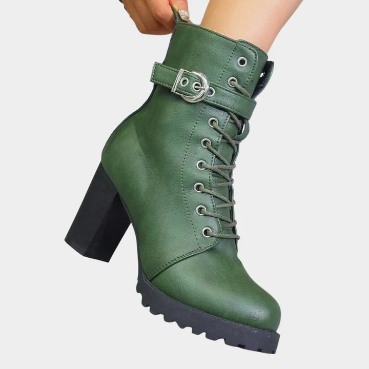 Stylish women's lace-up block heel ankle boots. Featuring a buckle strap & lug sole for fall fashion.