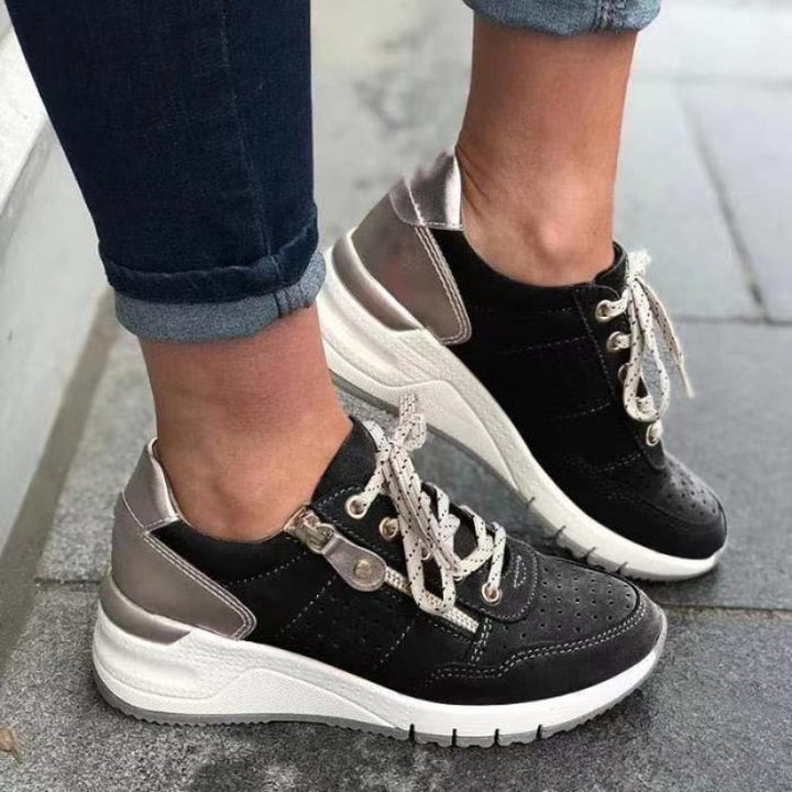 Practical women's walking sneakers, a perforated wedge platform design with lace-up and side zip.