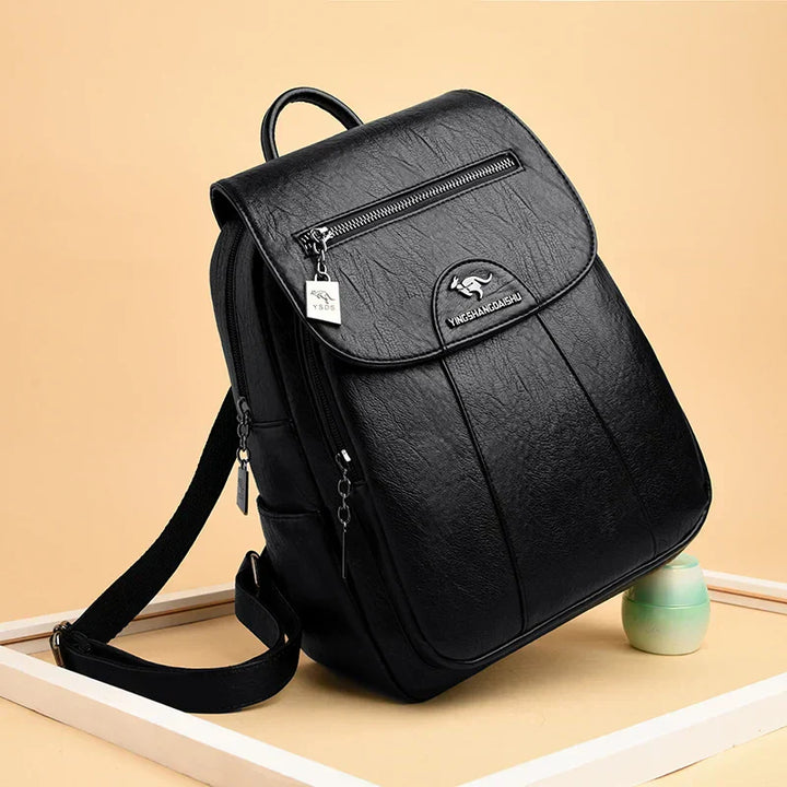 Women's large black leather backpack with anti-theft features.
