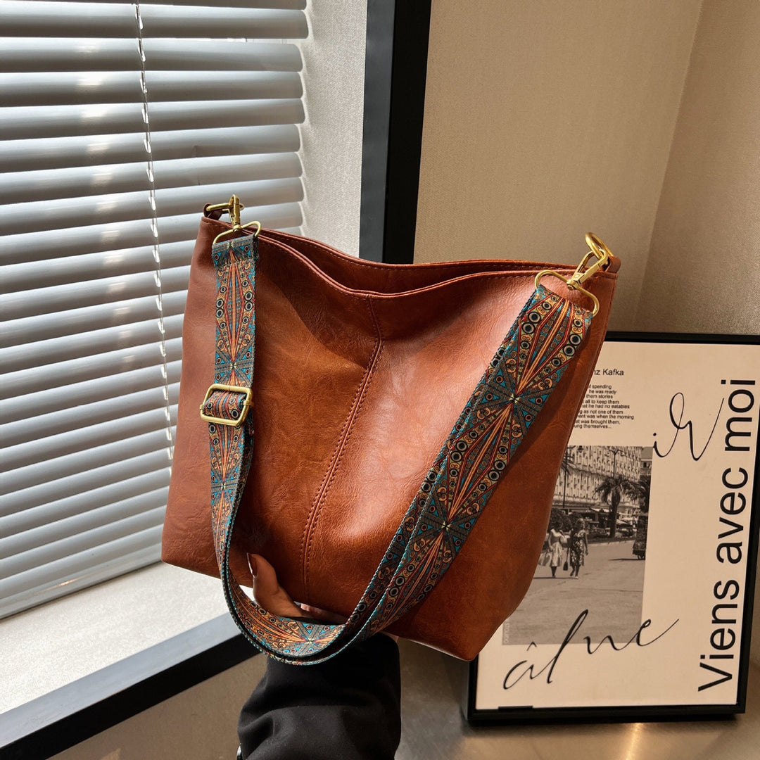 Versatile women's leather shoulder bag, large capacity for daily essentials, hobo style.