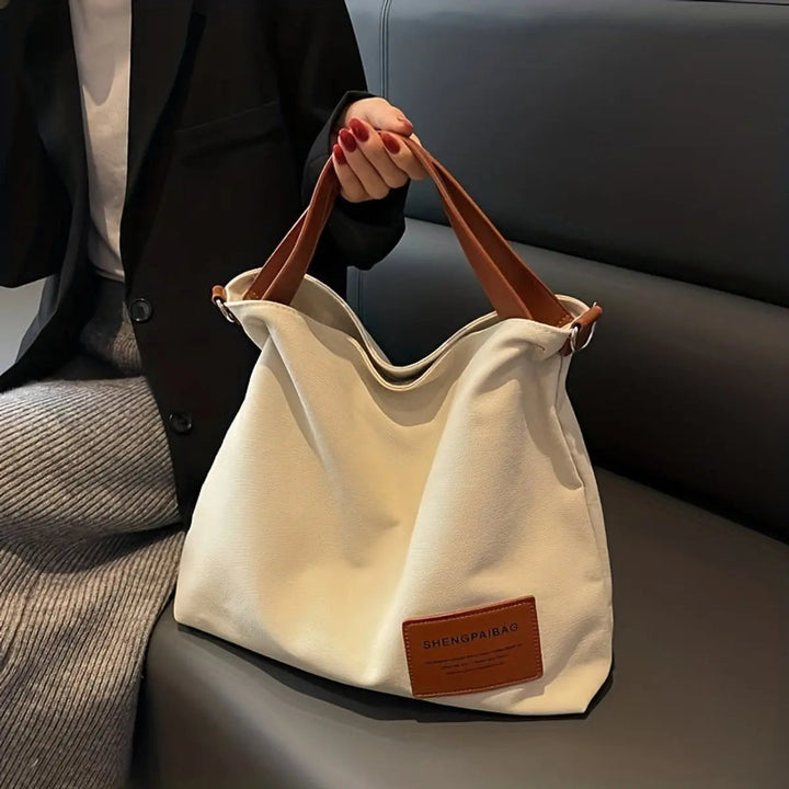 Elegant cream canvas large slouchy tote bag, a versatile women's shoulder or crossbody bag for casual style.