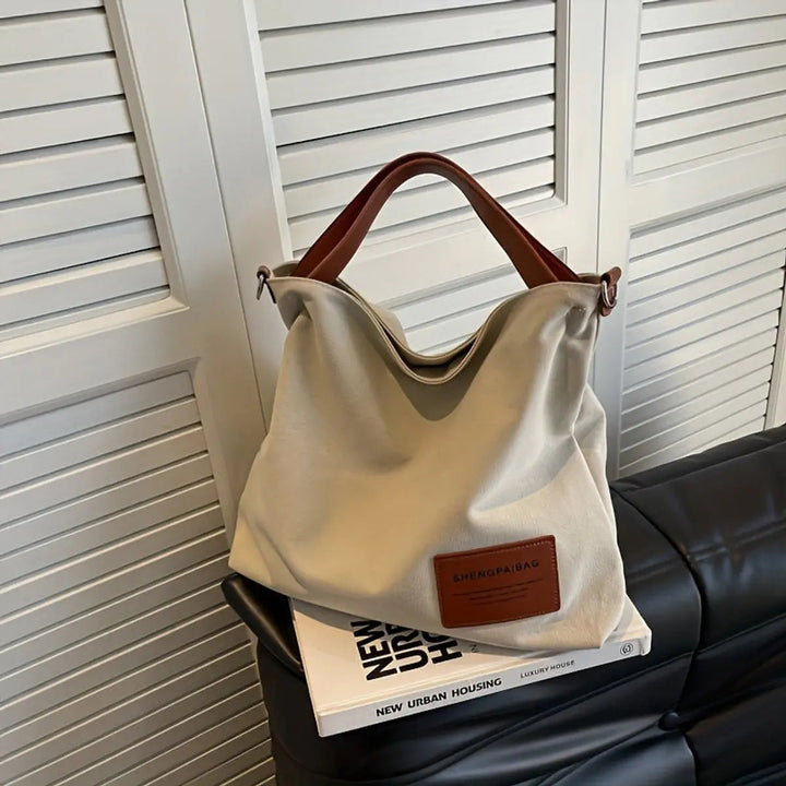 Spacious women's canvas slouchy tote bag with a comfortable adjustable strap, ideal as a shoulder or crossbody bag.