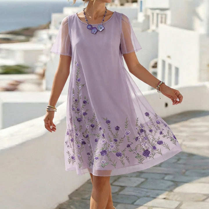 Women's lavender floral embroidered mesh mini dress with short sleeves, perfect for a romantic party look.