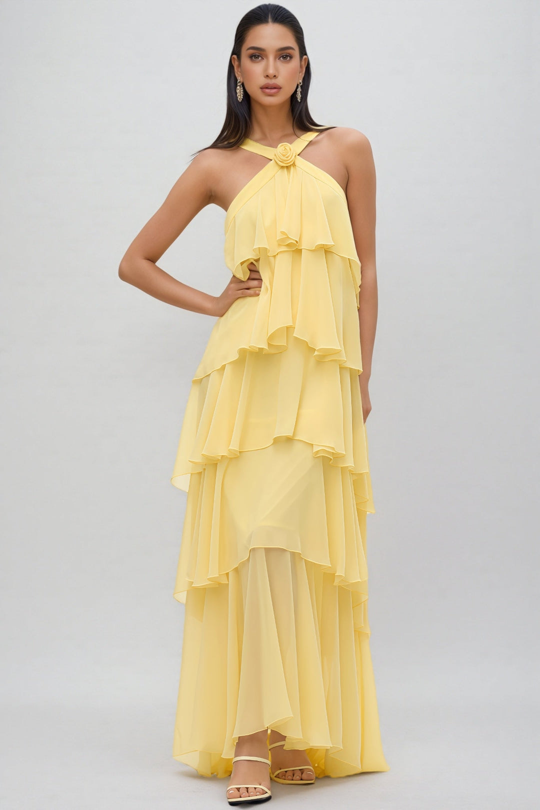 Statement yellow layered halter neck maxi dress with floral rosette detail, suitable for summer parties and events.