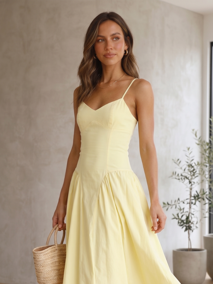 Elegant women's lemon yellow corset midi dress. Features spaghetti straps, babydoll style, and a flowing skirt, perfect for parties.