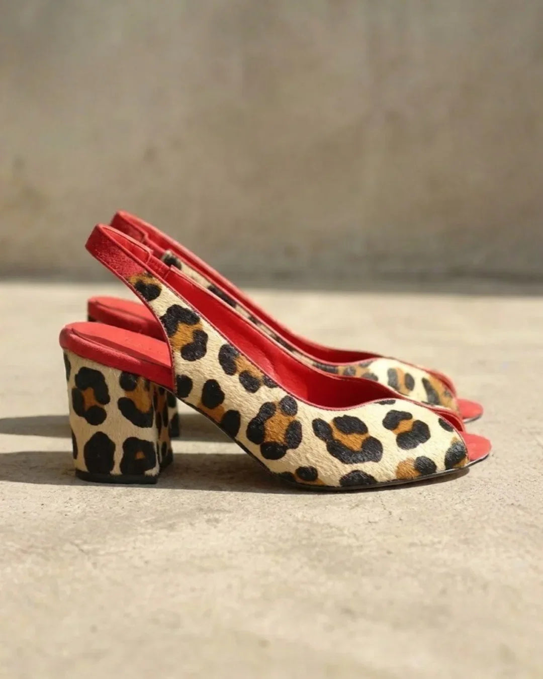 Elegant women's leopard print sandals featuring a comfortable block heel, stylish peep toe, and secure slingback.