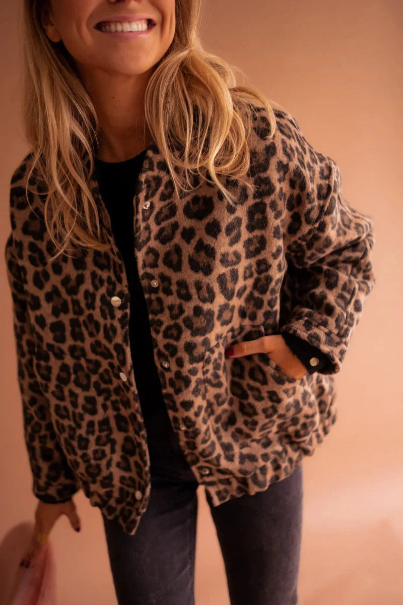 Women's leopard print bomber jacket with classic snap-button front closure.