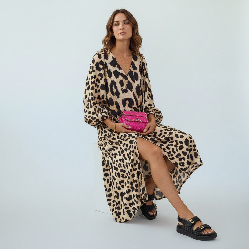 Women's leopard print midi dress with a flattering fit, perfect for elegant day to night wear.