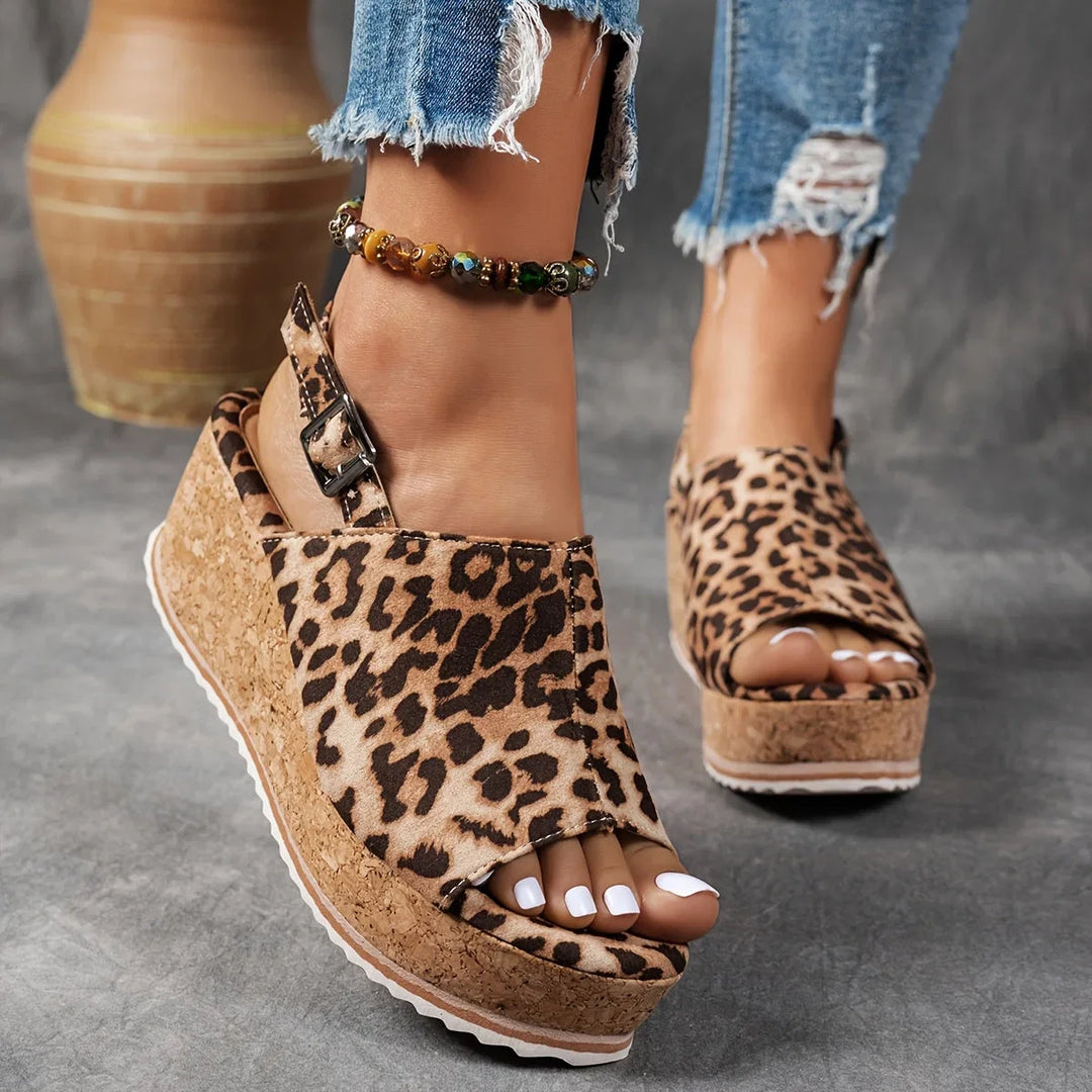Women's leopard print platform wedge sandals with an adjustable ankle strap for stylish summer comfort.