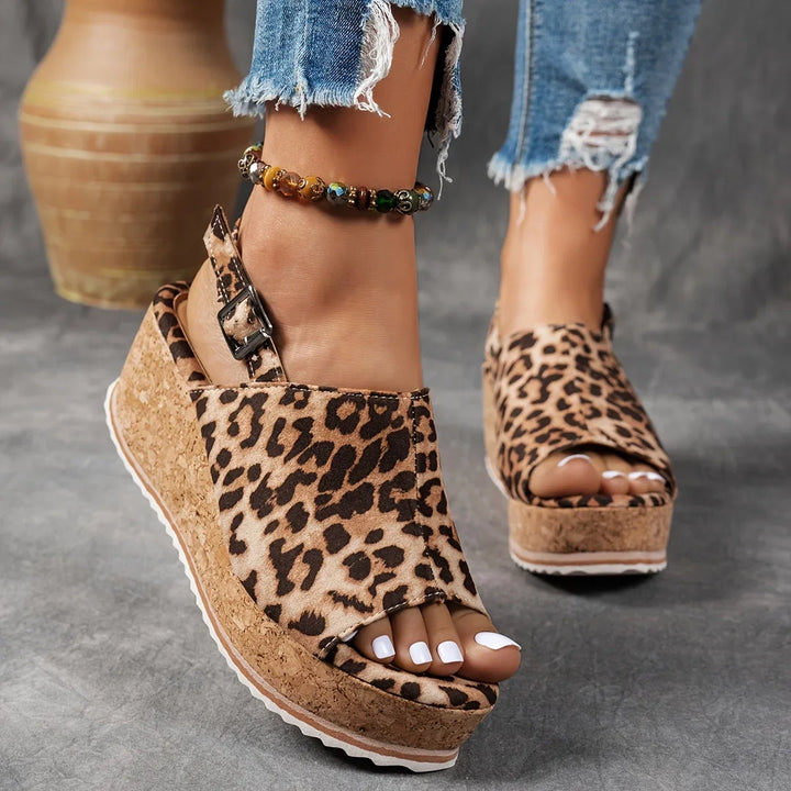 Women's leopard print platform wedge sandals with an adjustable ankle strap for stylish summer comfort.