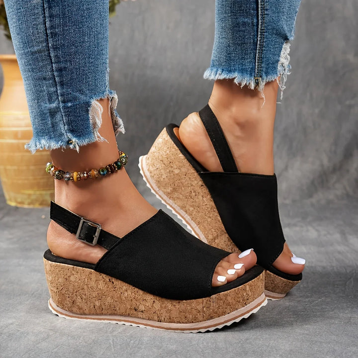 Stylish women's leopard platform wedge sandals, ideal for casual chic outfits. Features comfortable ankle strap.