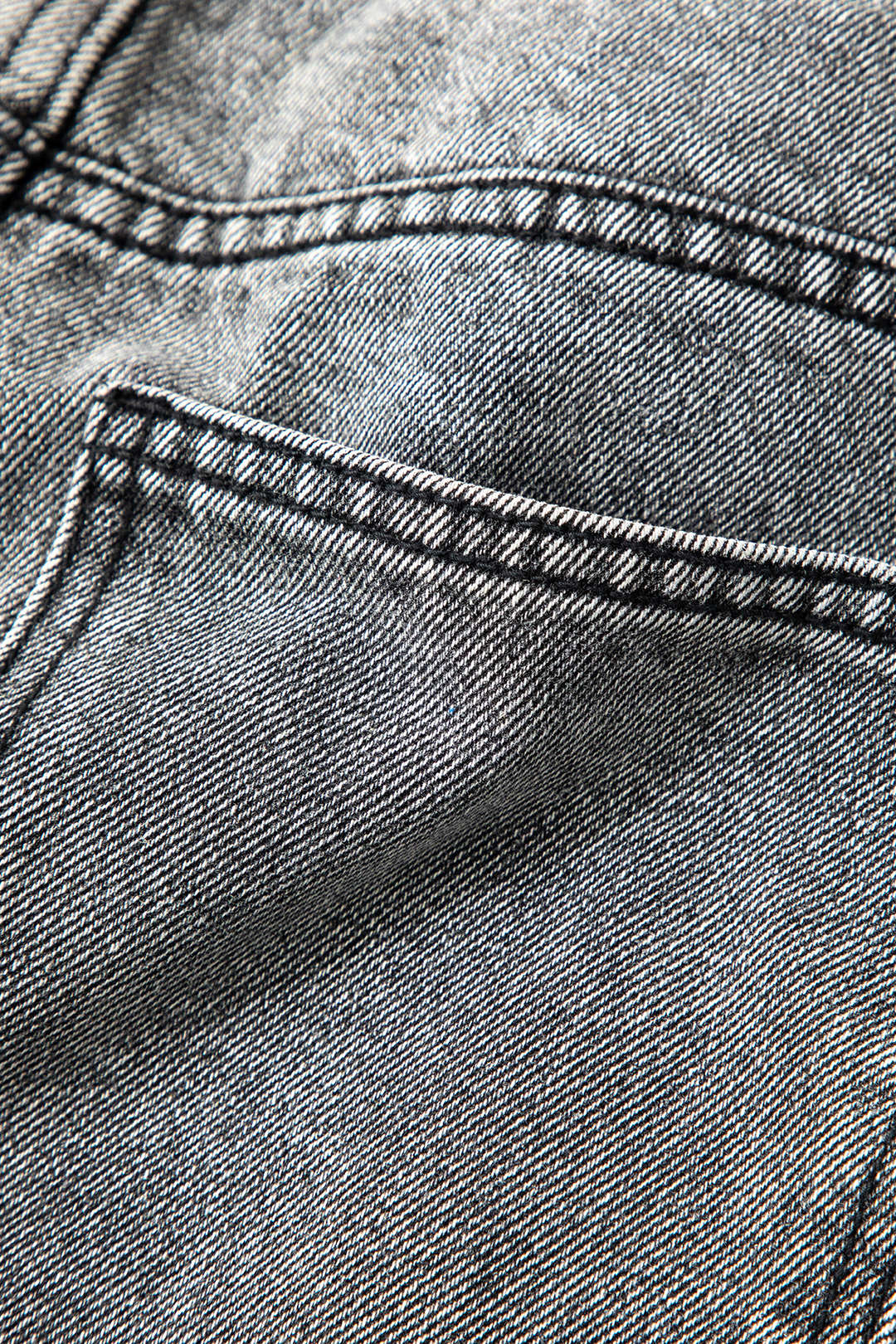 Woman wearing chic asymmetric high-waist straight leg jeans, styled as a complete fashionable outfit.