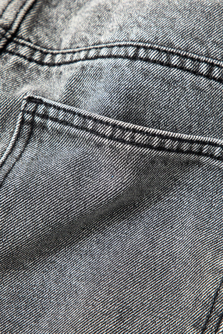 Woman wearing chic asymmetric high-waist straight leg jeans, styled as a complete fashionable outfit.
