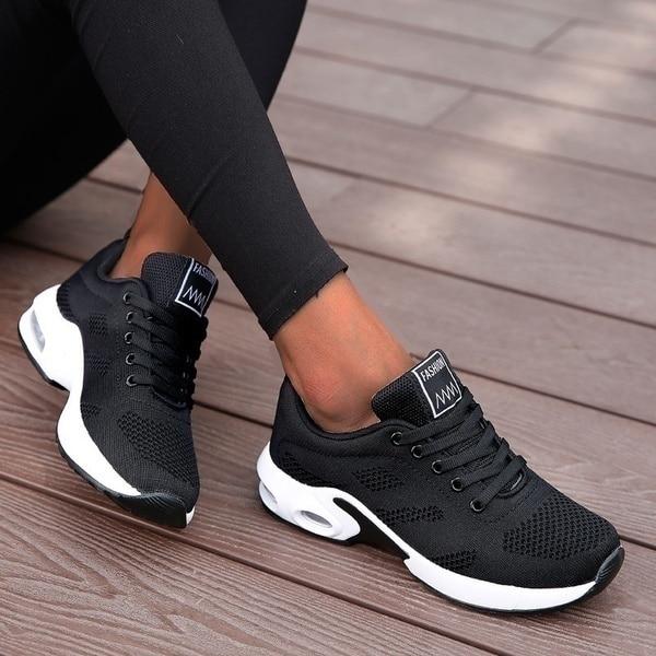 Close-up of breathable mesh on women's lightweight athletic running shoes for ultimate comfort.