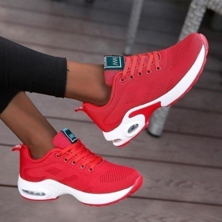 Pair of women's comfortable walking and running shoes, essential lightweight athletic trainers.