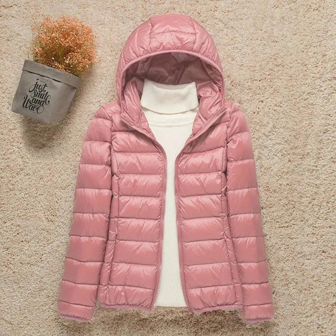 Hooded women's lightweight quilted puffer jacket. Insulated & packable for cold weather versatility & travel.
