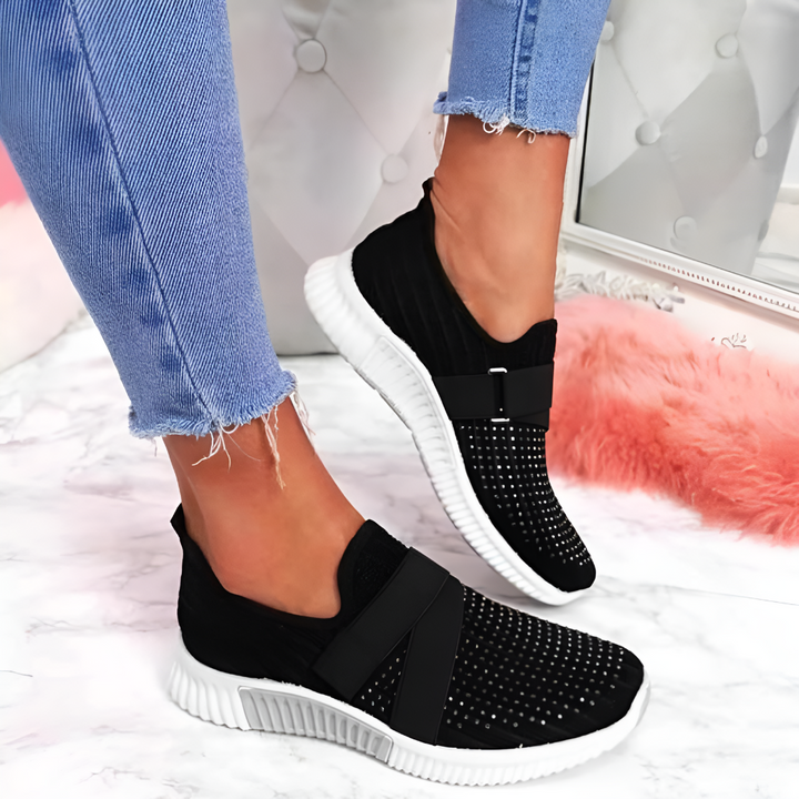 Stylish women's slip-on trainers, lightweight & comfortable with elastic strap for casual wear.