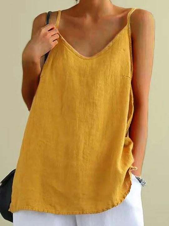 Model wearing a flowy, lightweight spaghetti strap top, ideal for a beach outfit.