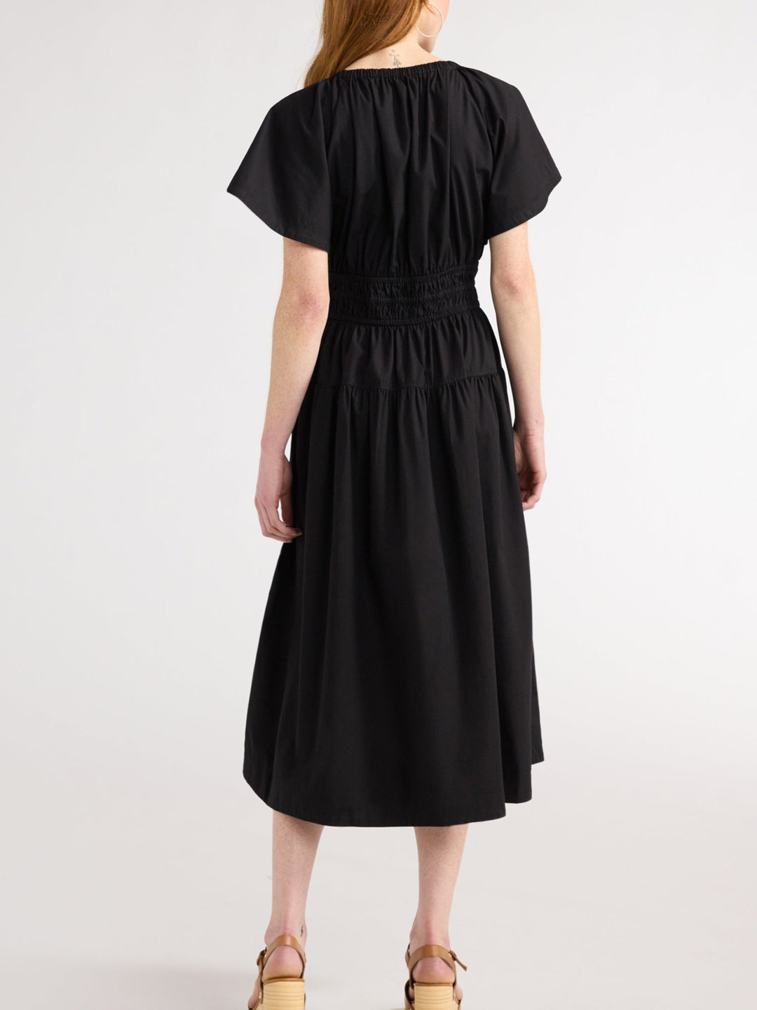 Lightweight flowy women's midi dress with tiered skirt and pockets. Provides an elegant and relaxed summer spring look.