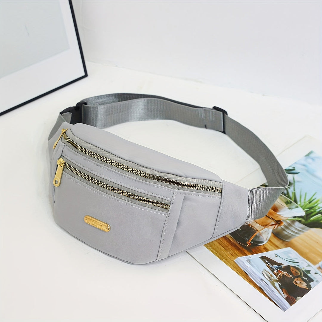 Front view of women's lightweight nylon waist bag, highlighting multi-zip pocket design.