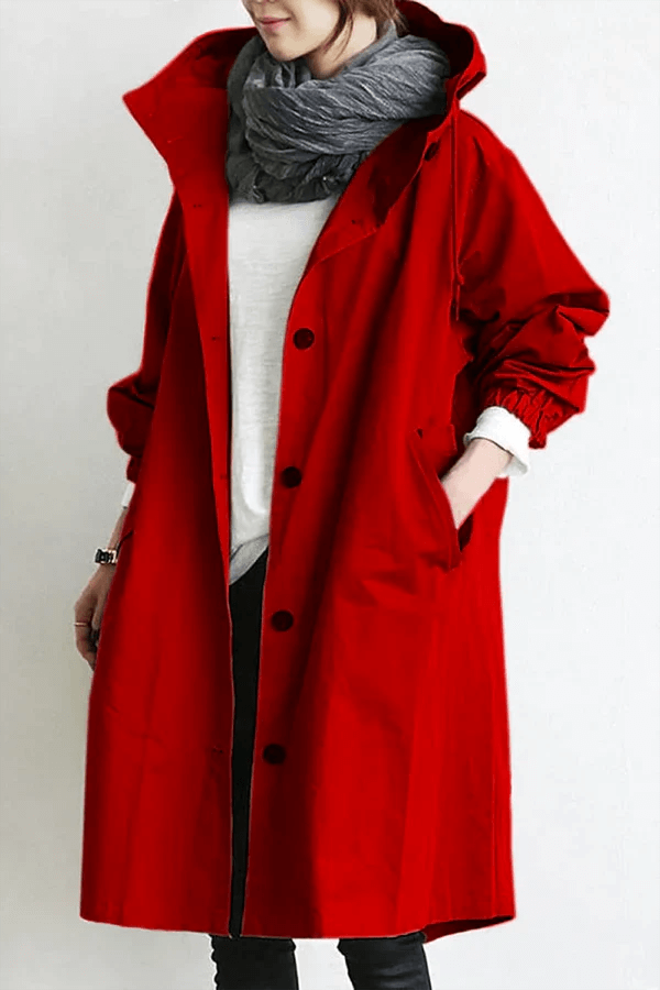 Packable women's travel rain cape. Lightweight waterproof jacket for stylish weather protection on the go.