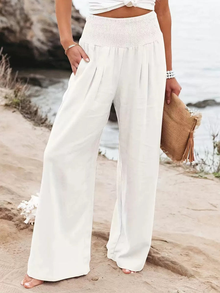 Women's lightweight wide leg linen trousers in natural beige, perfect for summer.