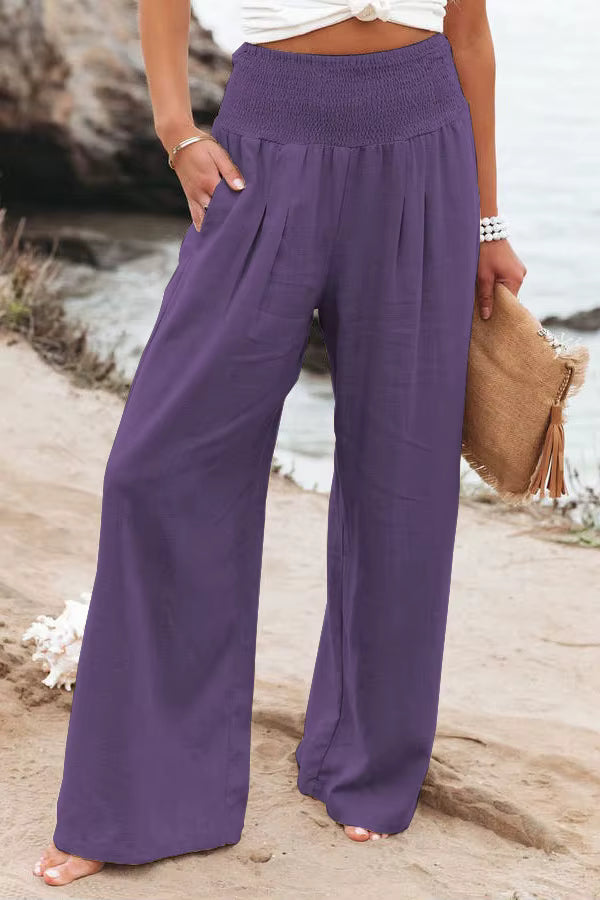 Back view of smocked waistband linen trousers, emphasizing comfort and fit.