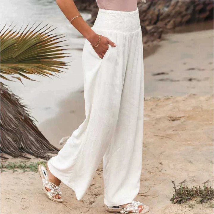 Model wearing breathable wide leg linen pants in a casual outdoor setting.