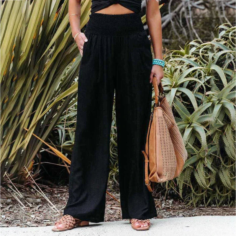 Pair of women's beige linen trousers, showcasing the wide leg design.