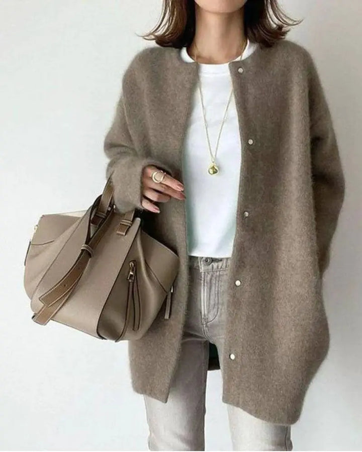 Close-up of the soft wool texture on a women's lightweight cardigan sweater.
