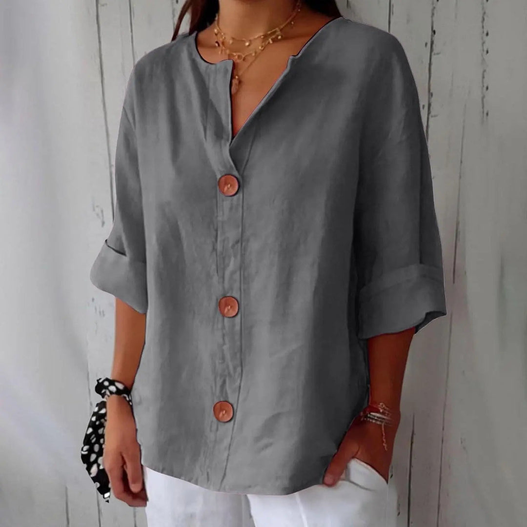 Relaxed fit women's linen top, featuring a stylish button front and three quarter sleeves for everyday elegance.