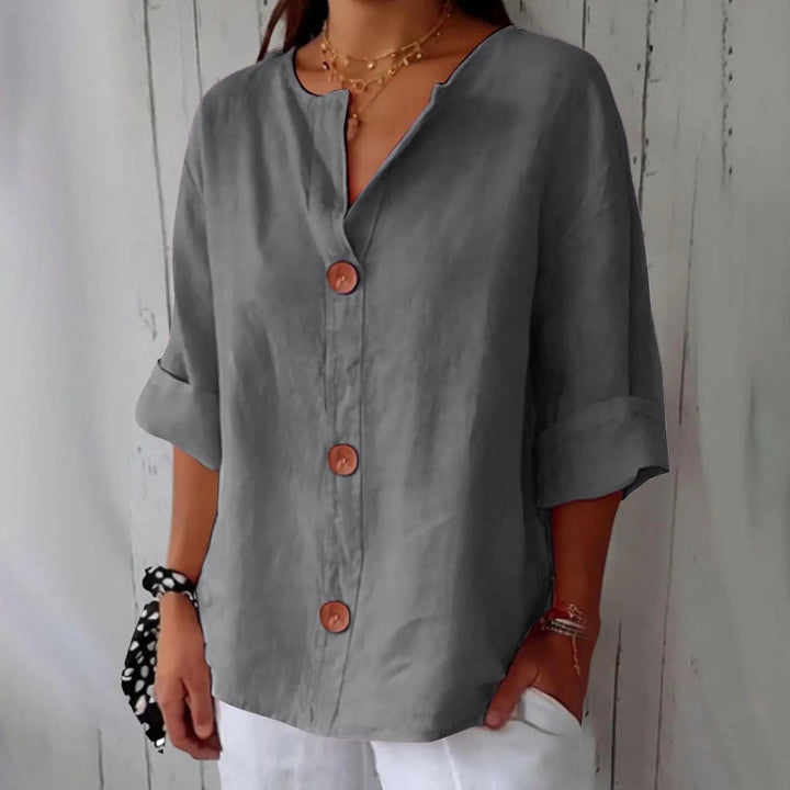 Relaxed fit women's linen top, featuring a stylish button front and three quarter sleeves for everyday elegance.