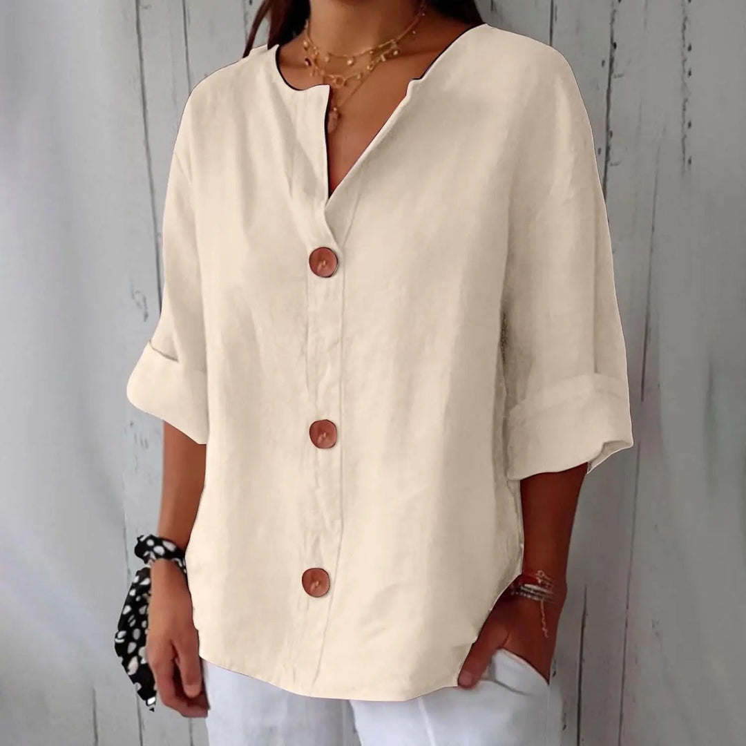 Elegant women's linen blouse with a button front design and three quarter sleeves for a sophisticated summer look.