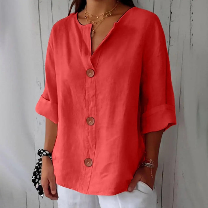 Stylish women's three quarter sleeve top with a full button front, offering a relaxed fit for versatile spring fashion.