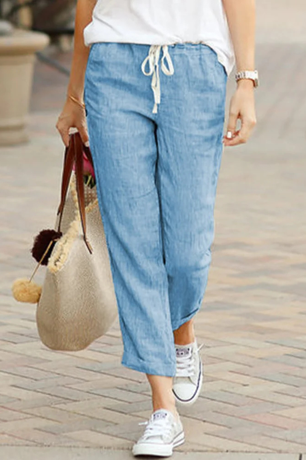 Soft, breathable women's linen cropped trousers with a practical drawstring waist, perfect for all-day comfort.