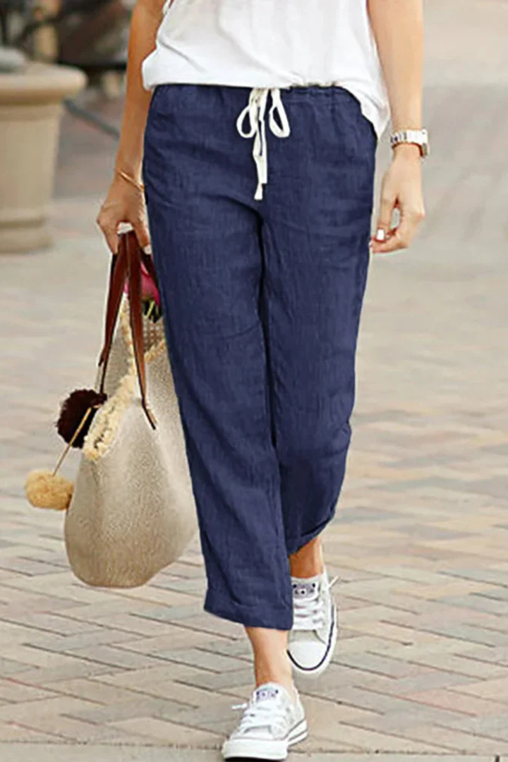 Versatile women's cropped linen trousers with drawstring waist, great for various casual and summer outfits.