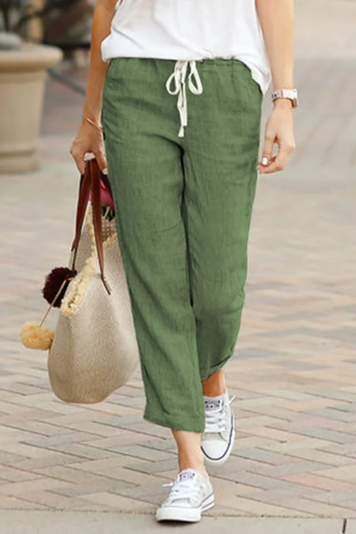 Lightweight women's linen cropped trousers with an adjustable drawstring waist, essential for summer fashion.